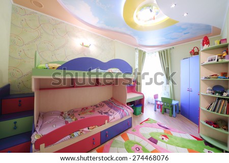 Interior of modern childrens room with colorful furniture and carpet