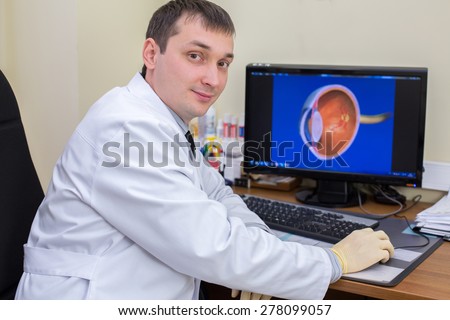 ophthalmologist at work behind a computer screen