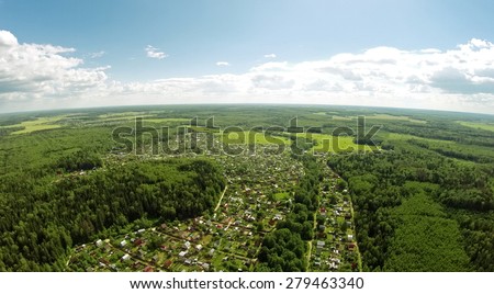 Cottage village among forest at summer sunny day. Aerial view