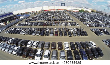 RUSSIA, MOSCOW - MAY 14, 2014: Lot of vehicles on parking for new car of Avtoframos company at spring sunny day. Aerial view