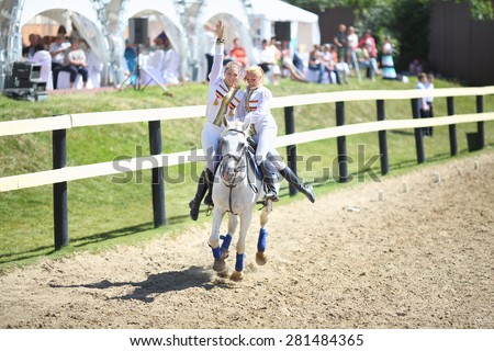 LYTKARINO, RUSSIA - MAY 23, 2014: Two horsewomen perform a task on a horse at the Russian Championship Dzhigitovka in equestrian sports complex Sozidatel in Lytkarino