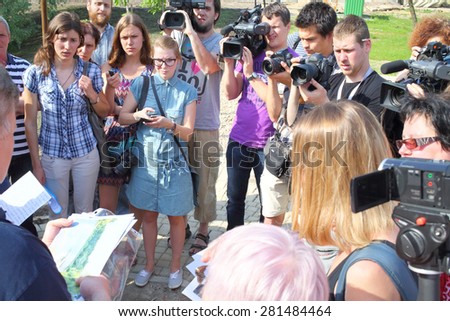 MOSCOW - MAY 19, 2014: A group of reporters about taking interview in recreated relaxation area in the national park Losiny Ostrov
