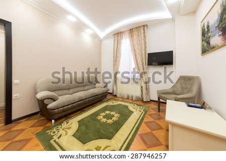 ADLER, RUSSIA - JULY 22, 2014: Interior of a hotel room with sofa, chair and carpet in Shine House hotel