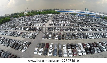 RUSSIA, MOSCOW  JUN 7, 2014: Aerial view lot of vehicles on parking for new car of Avtoframos company at spring sunny day. Photo with noise from action camera