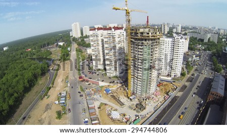 RUSSIA, MOSCOW - MAY 19, 2014: Builders work at construction site of residential complex Falcon Fort at sunny spring day. Aerial view