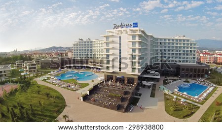 RUSSIA, SOCHI - JUL 26, 2014: Edifice of Radisson Blu hotel with signboard on roof at summer day. Aerial view. Photo with noise from action camera.