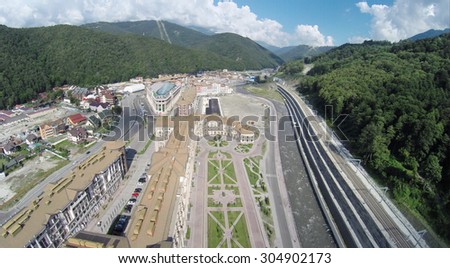 SOCHI, RUSSIA - AUG 1, 2014: The new building of hotel complex Gorky Gorod Apartments in Krasnaya Polyana, aerial view
