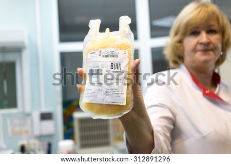 MOSCOW - November 10, 2014: Doctor holding a bag with deep-frozen human plasma