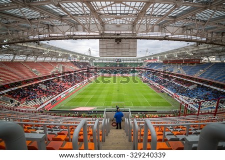 RUSSIA, MOSCOW - NOV 02, 2014: Operator shoots video of football match on the field of Locomotive sports arena.