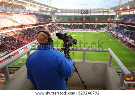 RUSSIA, MOSCOW - NOV 02, 2014: Close-up view of operator shoots video of football match on the field of Locomotive sports arena.