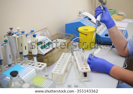Workplace with automatic pipettes and test tubes with the analysis in the laboratory
