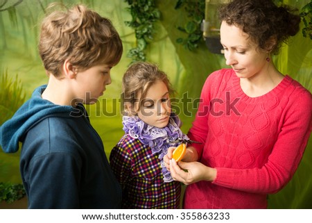 RUSSIA, MOSCOW - OCT 12, 2014: Mother, boy and girl (with model release) in park of butterflies.