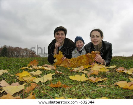 smile faces of family on autumn leaves