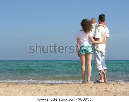 back family of thre on beach
