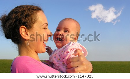faces mother with baby on sunset with cloud