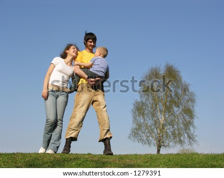family stand with son. spring