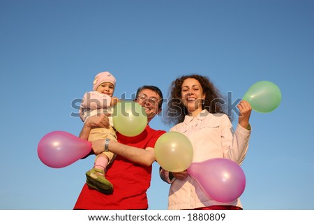 family with baby and balloons