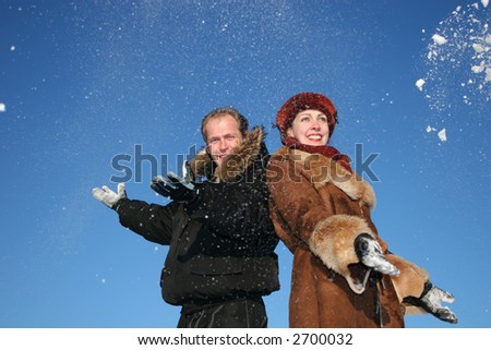 winter couple throw snow