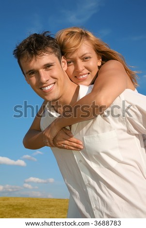 woman embraces man from behind