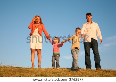 dad and mom hold children for the hands