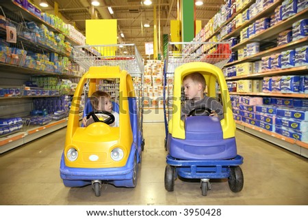 children in the toy automobiles in the store