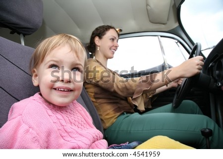 child with mother in car