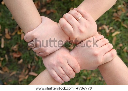 four hands hold each other