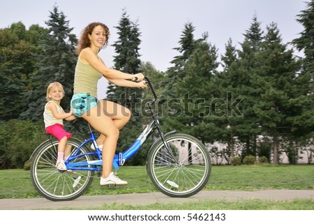 Mother and daughter ride on bicycle 2