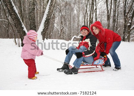 winter family on sled