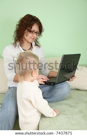 young woman in eyeglasses with notebook and child