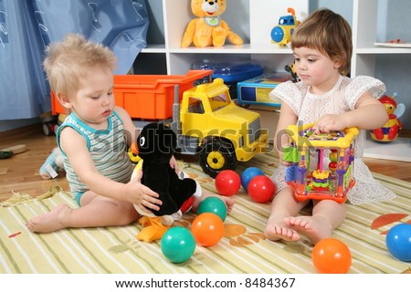 two children in playroom with toys