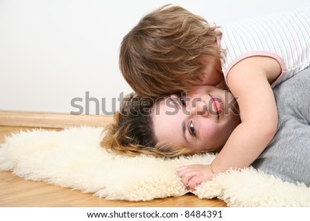 mother with child lie on fur carpet