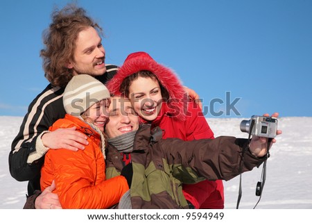 group of friends photographs itself in winter