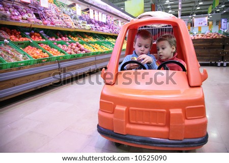 children in toy automobile in store