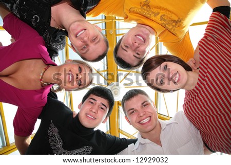 group of friends it  smiling after being embraced into the circle it looks downward
