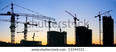 construction cranes silhouette sunset