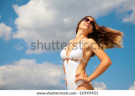 Girl in bathing suit with being fluttered hair