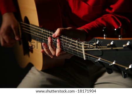 Close-up hands with guitar