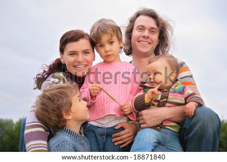 Family of five portrait on nature