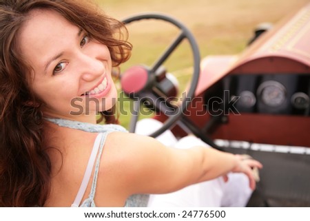 Woman sits having turned back in salon of the ancient car