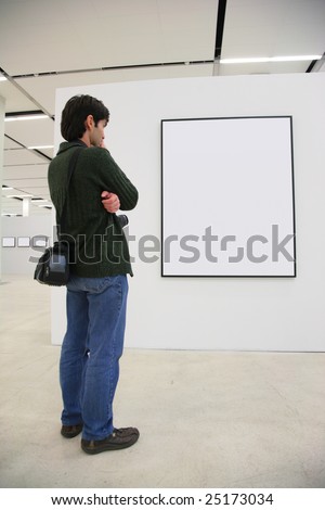 Visitor looks on frame in showroom