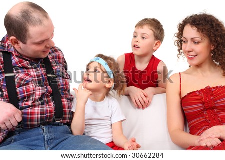 Close up portrait of family with two children on white leather sofa