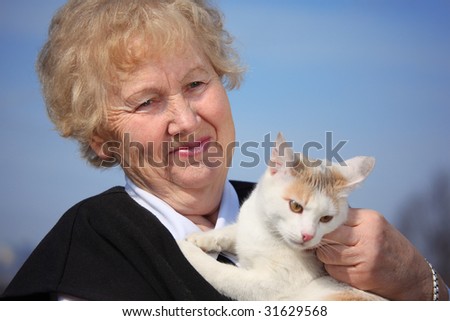 Portrait of aged woman with cat on sky