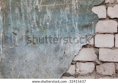 Brick wall with fallen off plaster