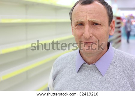 elderly man face and empty shelves in  shop