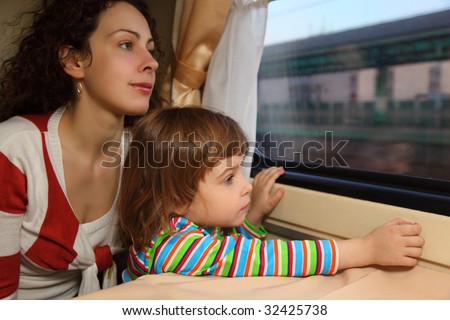 mother and daughter look in train`s window