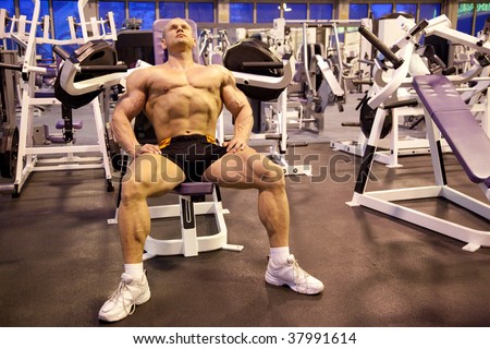 bodybuilder rests in training room