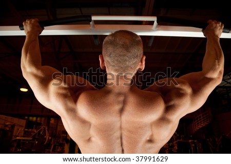 bodybuilder back pull-up in training room