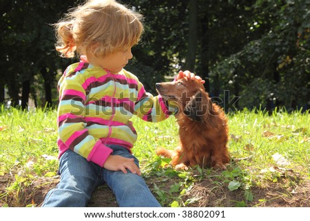 http://image.shutterstock.com/display_pic_with_logo/4225/4225,1255437489,42/stock-photo-little-girl-caress-dachshund-outdoor-38802091.jpg