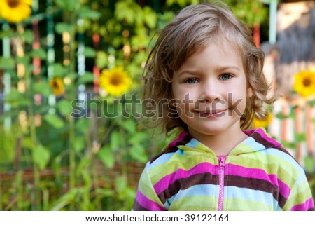 closeup portrait of young girl outdoors with sunflowers